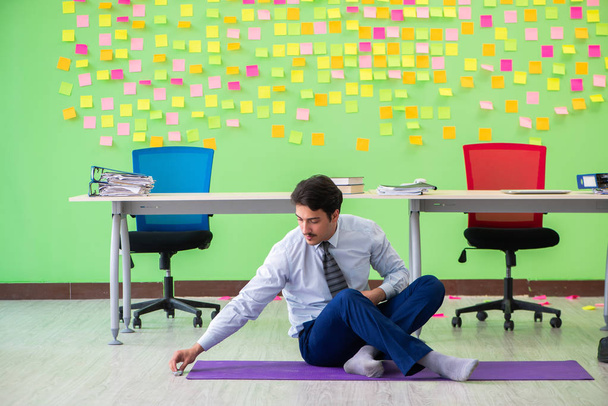 Muž v kanceláři s mnoha protichůdnými prioritami cvičení - Fotografie, Obrázek