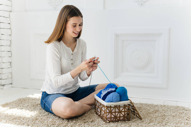 a woman knitting warm socks at home - Foto, Imagen