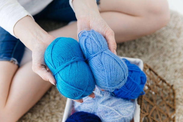 a woman knitting warm socks at home - Фото, зображення
