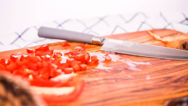 Step by step. Slicing red bell pepper on a wood cutting board. - Photo, Image