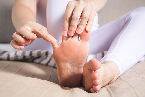 Woman's leg hurts, pain in the foot, massage of female feet at home - Fotoğraf, Görsel