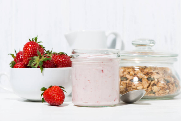 sweet strawberry yogurt, granola and fresh berries on white background, closeup - Foto, Imagen