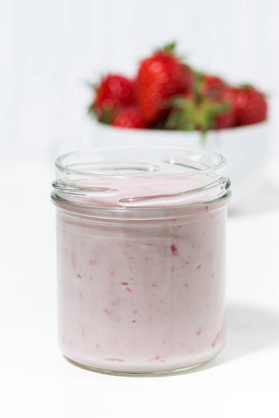 sweet strawberry yogurt and fresh berries on a white background, closeup - Фото, зображення