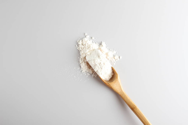 flour spoon spatula on a light background - Φωτογραφία, εικόνα