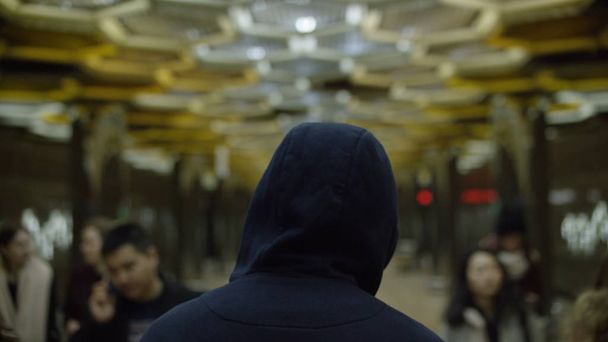 Rear view of a single hooded man in the subway. Concept of loneliness - Photo, Image