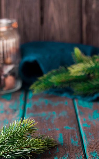 Christmas mood decoration. Rustic style Christmas. Spruce branches and wooden desk. Space for text. Toned photo. - Foto, Imagem
