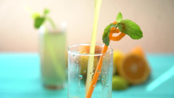 Pouring freshly squeezed orange juice into a glass - Кадри, відео