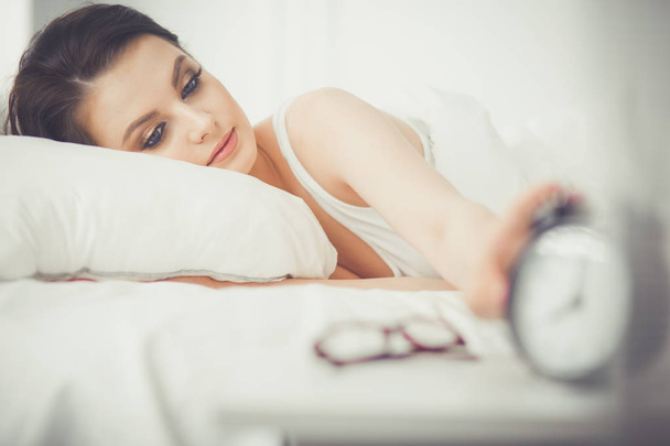 Young beautiful woman lying in bed. - Fotografie, Obrázek