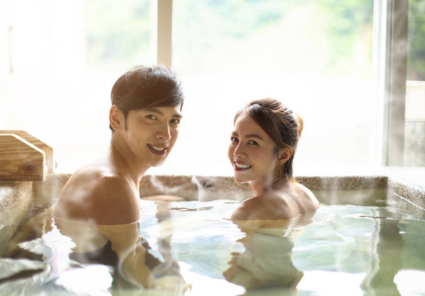 Young couple relaxing in hot springs  - Foto, Imagen