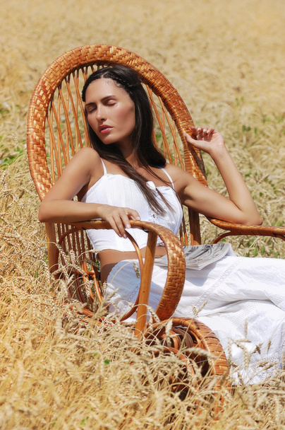 beautiful girl sleeping in a chair in the field - Photo, Image