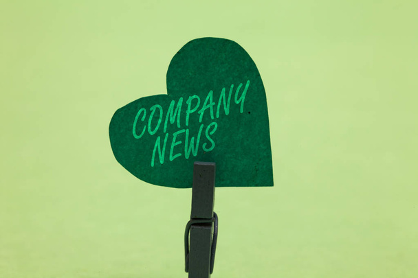 Writing note showing Company News. Business photo showcasing Latest Information and happening on a business Corporate Report Clothespin holding green paper heart important romantic message ideas - Photo, Image