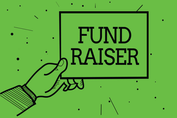 Text sign showing Fund Raiser. Conceptual photo person whose job or task is seek financial support for charity Man hand holding paper communicating information dotted green background - Photo, Image