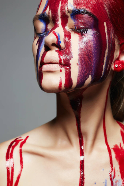 Dziewczyna z farby na jej twarzy. płynne farby przepływającym przez piękną twarz i ciało. Kolor portret kobiety w programie Paint - Zdjęcie, obraz
