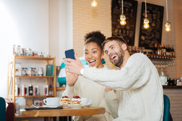 Beaming young couple making funny selfie together - Foto, immagini