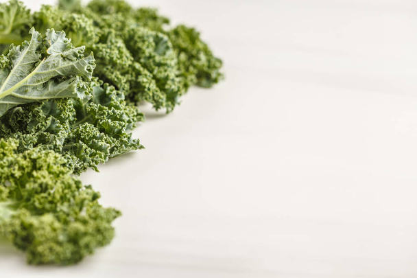 Fresh green leaves of kale on white background. Clean eating concept. - Fotografie, Obrázek