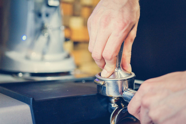 barman prepares coffee in a coffee machine - Fotó, kép