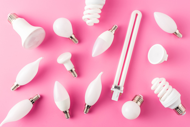 top view of various types of light bulbs on pink   - Fotó, kép