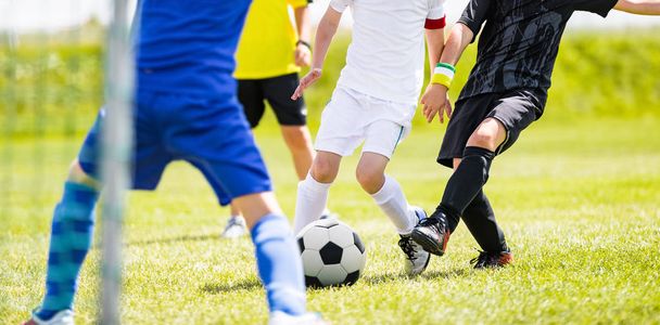 Kinderen schoppen Voetbal bal op groen grasveld. Buitensport jeugdcompetitie voor kinderen - Foto, afbeelding