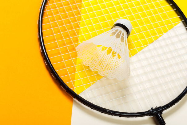 Shuttlecock and badminton racket on colorful background - Photo, image