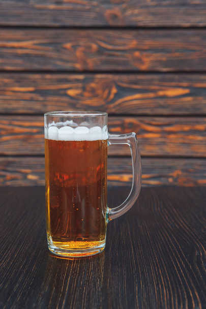 Close-up of a glass of beer on a wooden table. wooden background. - Fotografie, Obrázek