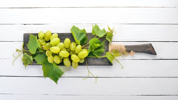 Grape. Fresh white grapes on a white wooden background. Top view. Free space for text. - Φωτογραφία, εικόνα