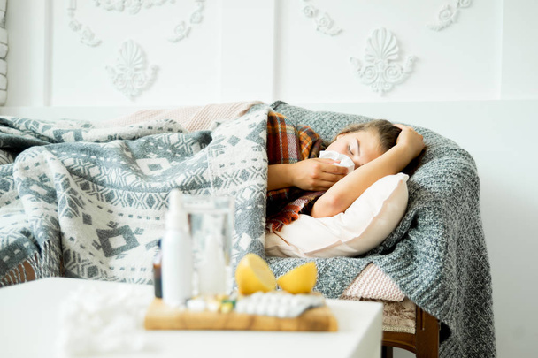 ill young girl with fever spending time at home - Foto, imagen