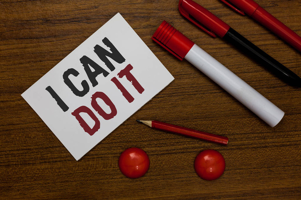 Writing note showing I Can Do It. Business photo showcasing ager willingness to accept and meet challenges good attitude White paper markers wooden background communicating ideas messages - Photo, Image