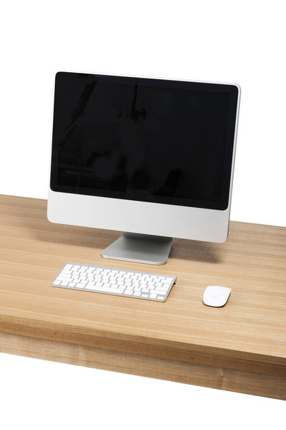 computer on the wood table on the white background. - 写真・画像