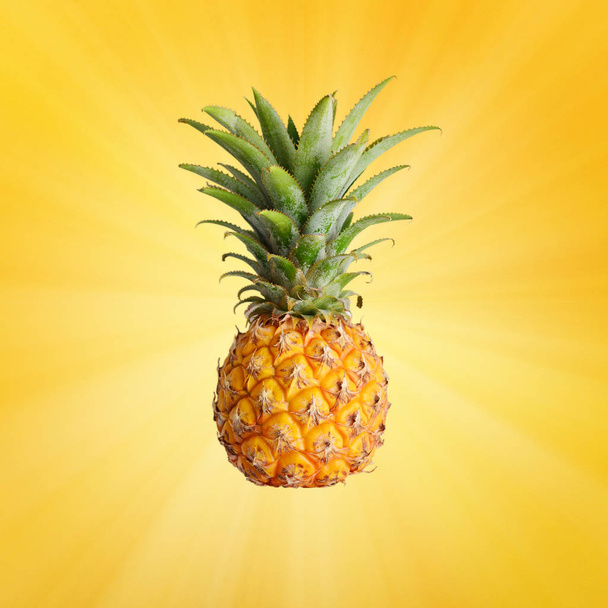 Fresh ripe whole pineapple fruite on yellow background - Foto, afbeelding