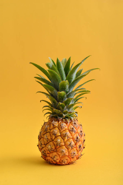Fresh ripe whole pineapple fruite on yellow background - Foto, imagen
