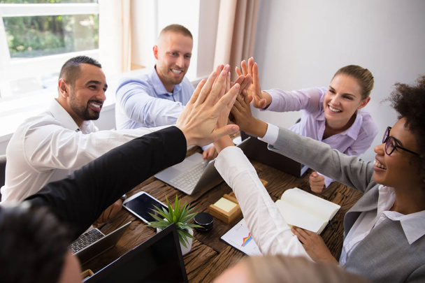 Group Of Happy Young Businesspeople Giving High Five In Office - Fotoğraf, Görsel