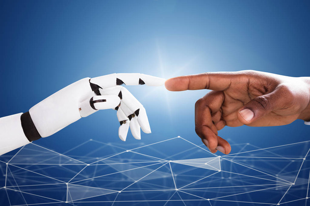 Robot Touching Man's Index Finger Against Digital Backdrop - Foto, immagini
