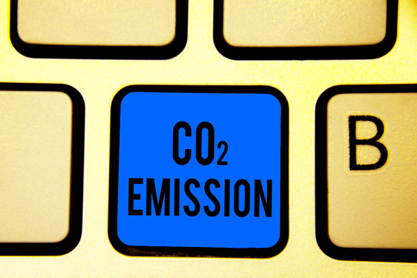 Conceptual hand writing showing Co2 Emission. Business photo text Releasing of greenhouse gases into the atmosphere over time Keyboard blue key Intention computer computing reflection document - Photo, Image