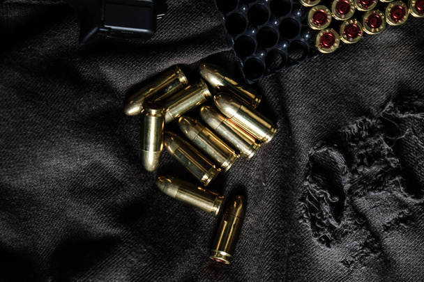 Full metal jacket 9mm Rüger golyó a ruha textúrája kar objektum - Fotó, kép