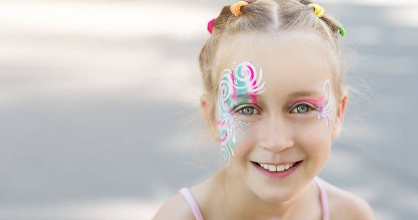 Pretty little girl with painted face - 写真・画像