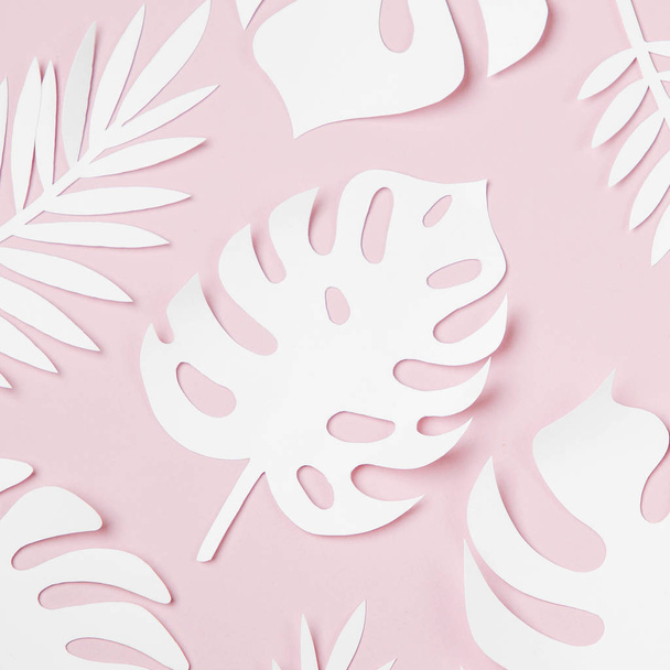 pink background with tropical leaves made of white paper  - Foto, immagini