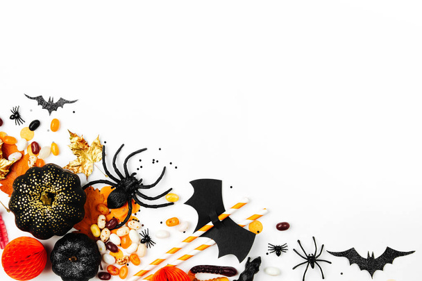 Halloween holiday background with candies, bats, spiders, pumpkins and decorations - Valokuva, kuva