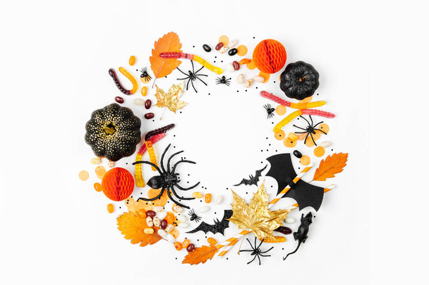 Halloween holiday background with candies, bats, spiders, pumpkins and decorations - Photo, image