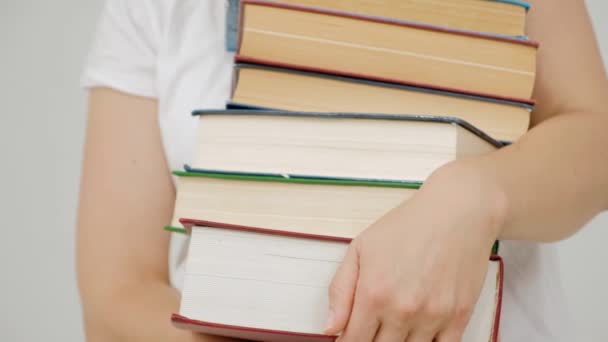 College female student on university campus holding many books in hands - Video, Çekim