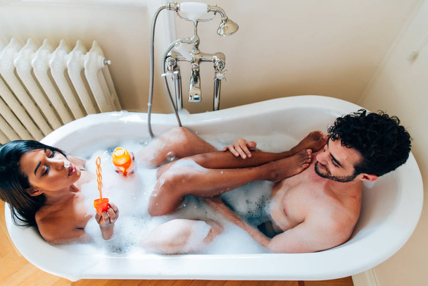 Couple in love spending time together in the house. Romantic moments in the bathroom - 写真・画像