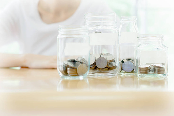 The woman hid behind a jar full of coins - Fotó, kép