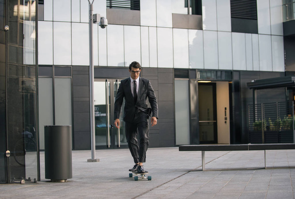 Handsome young business man with his modern longboard - Fotografie, Obrázek