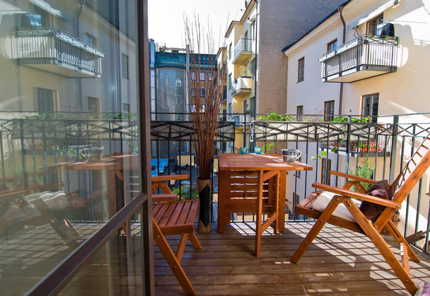 relaxing chairs on a balcony in a residential community in the city - Photo, image