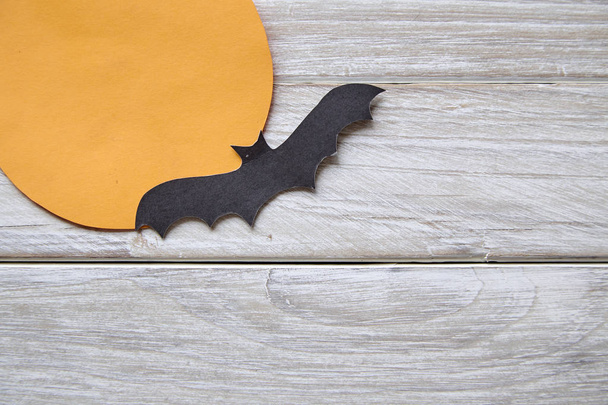Halloween holiday moon paper with paper bats on the old white wood table background - 写真・画像