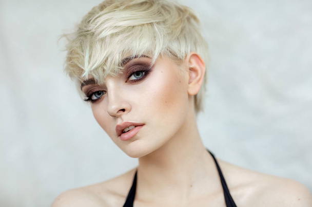 Beauty portrait of blond model in fashionable haircut - Fotó, kép