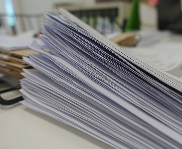 Pile of white paper report for meeting on office desk. - Photo, Image