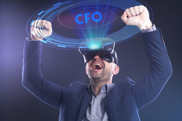 The concept of business, technology, the Internet and the network. A young entrepreneur working on a virtual screen of the future and sees the inscription: CFO - Photo, Image