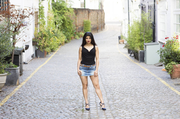 beautiful indian woman standing alone on a quiet street - Photo, Image
