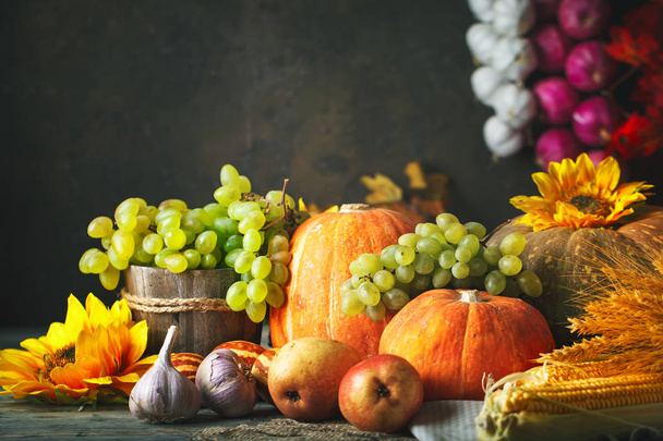 Happy Thanksgiving Day background, wooden table decorated with Pumpkins, Maize, fruits and autumn leaves. Harvest festival. Selective focus. Horizontal. Background with copy space. - Photo, Image