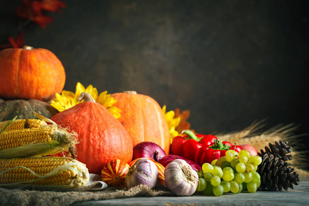 Happy Thanksgiving Day background, wooden table decorated with Pumpkins, Maize, fruits and autumn leaves. Harvest festival. Selective focus. Horizontal. Background with copy space. - Fotó, kép